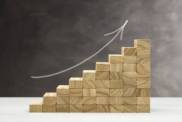Concept of growth. Graphic with wooden steps on grey background with arrow drawn.